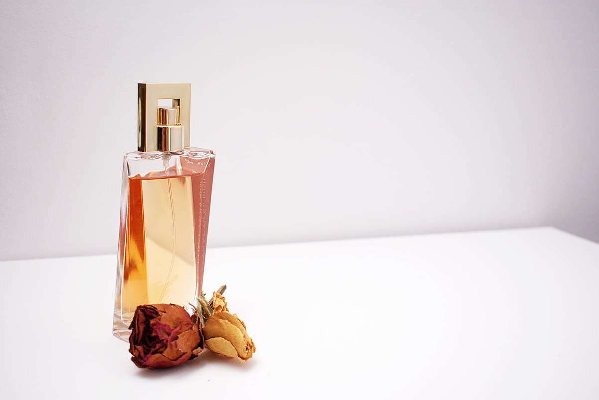 A bottle of perfume sitting on top of a table.