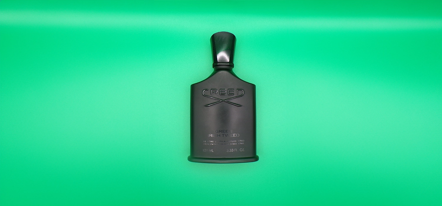 A bottle of whiskey on a green background