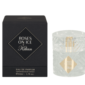 A bottle of perfume sitting next to its box.