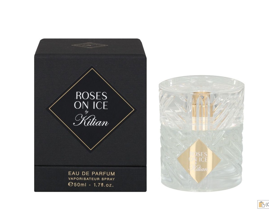 A bottle of perfume sitting next to its box.