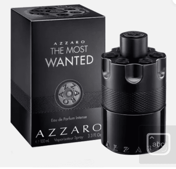 A black bottle of perfume sitting next to its box.