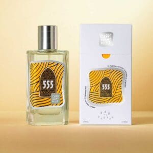 A bottle of perfume next to its box.