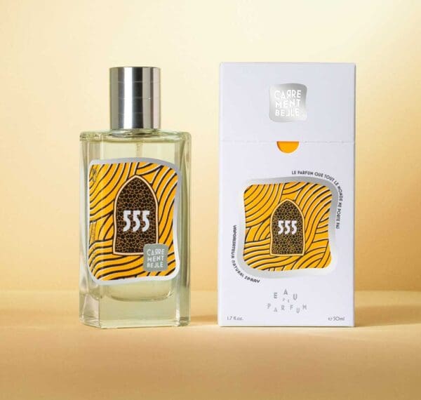 A bottle of perfume next to its box.