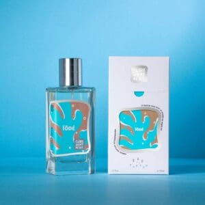 A bottle of perfume next to its box.