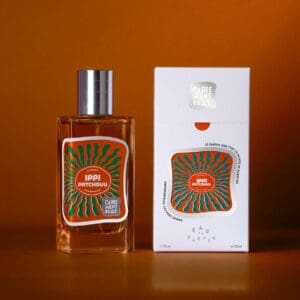 A bottle of perfume next to its box.