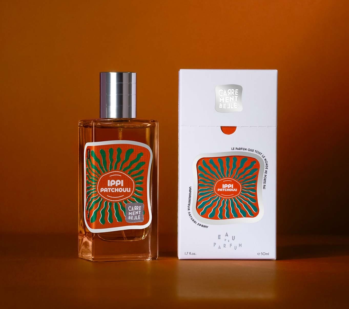 A bottle of perfume next to its box.