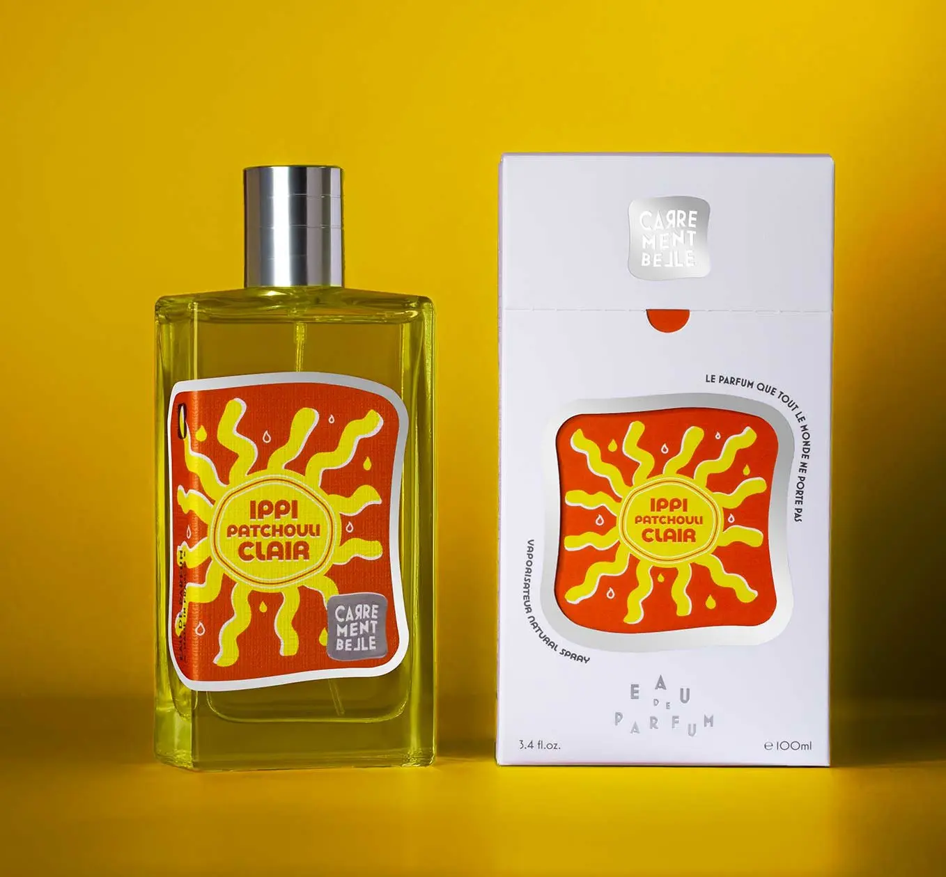 A bottle of sun flower scent next to its box.