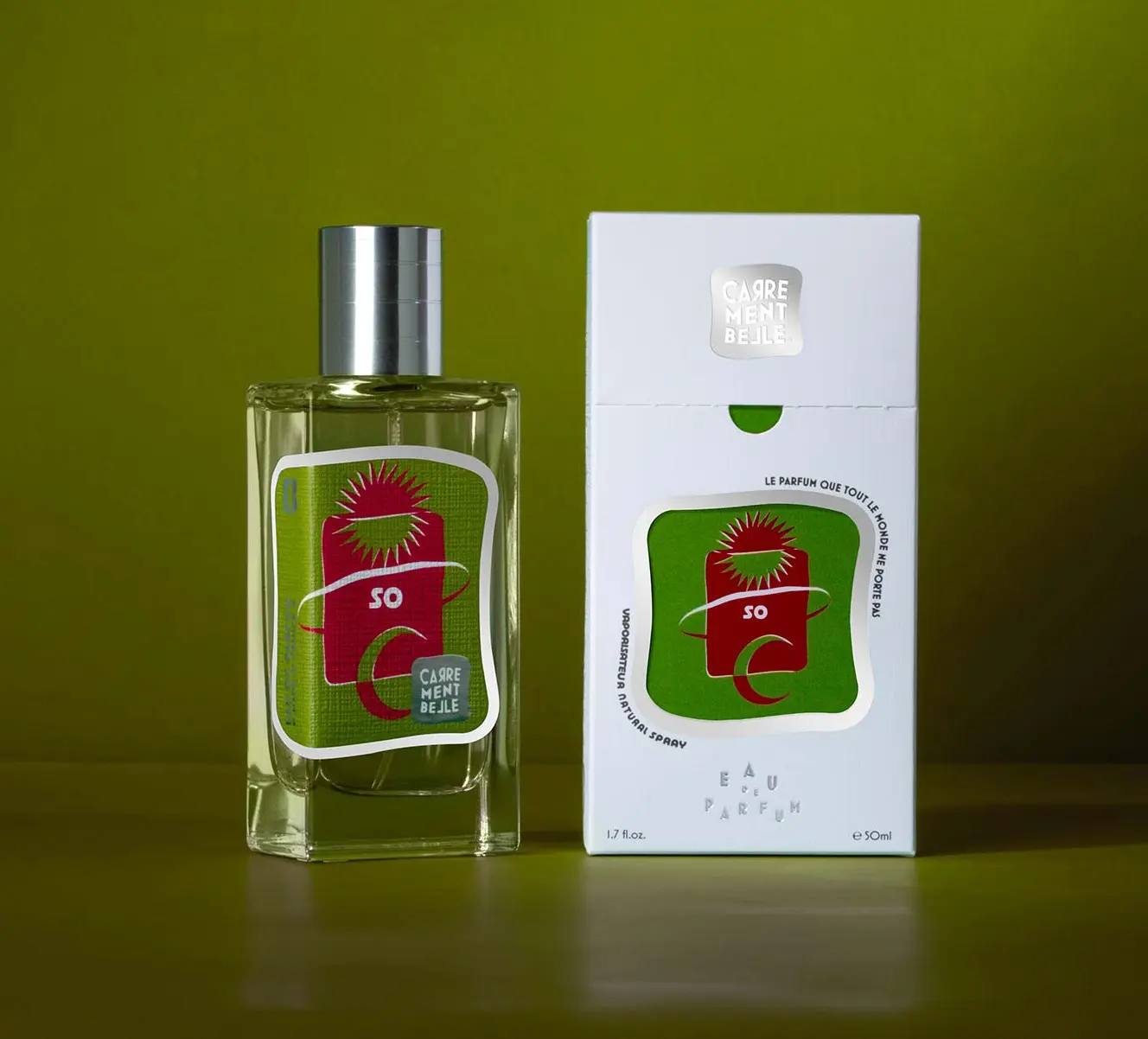 A bottle of perfume sitting next to its box.