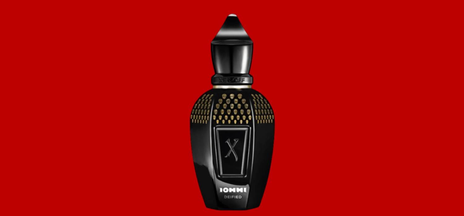 Black perfume bottle on red background.