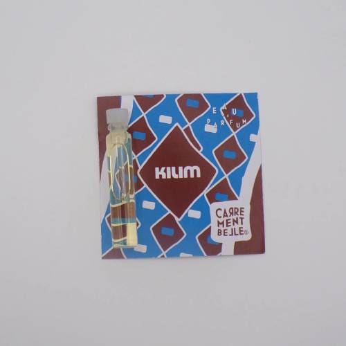 Perfume sample with colorful geometric packaging.